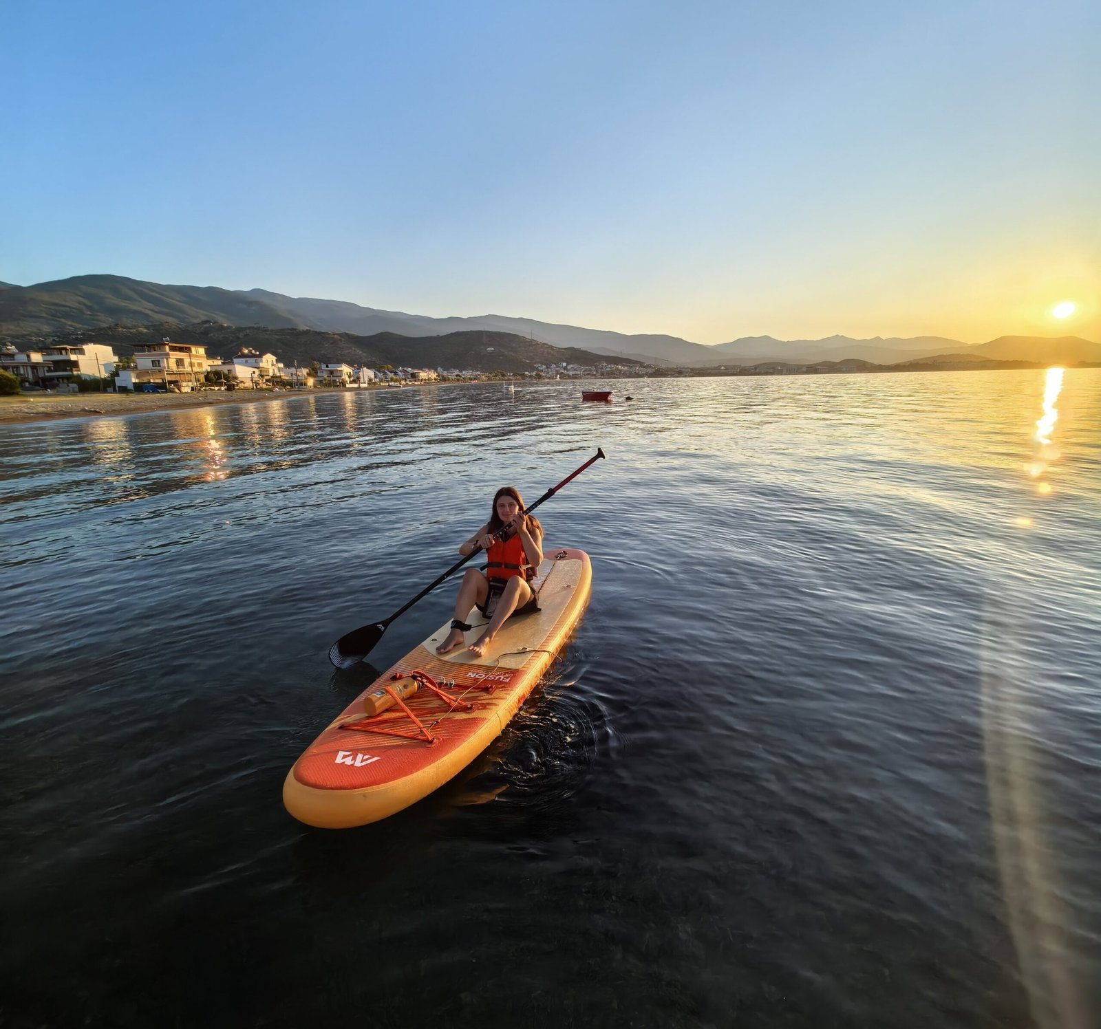 Paddler on a stand up paddle board at sunset on the Turkish Aegean coast